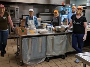 Volunteers wear matching face masks as they prepare a meal for the Anchorage breakfast program. (Photo provided by Anchorage)