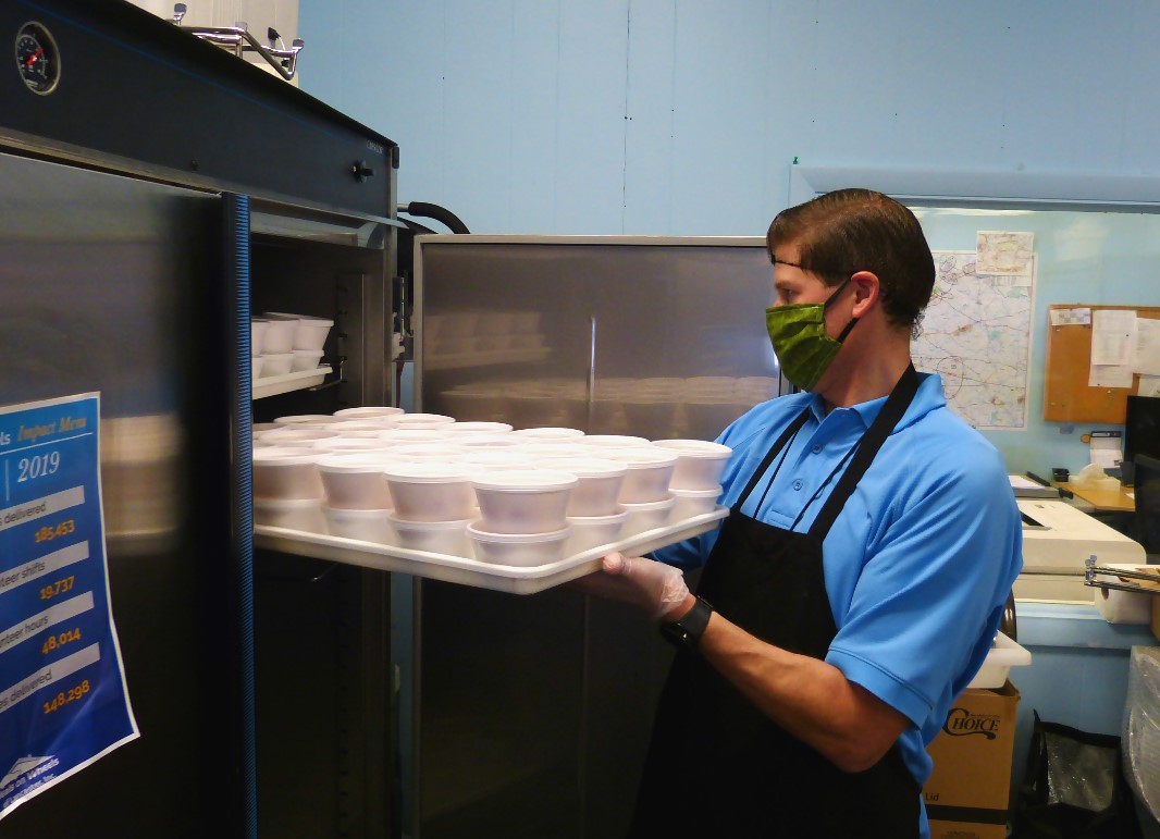 Darin Viergutz slides a tray of pound cake desserts into a refrigerator at Meals on Wheels of Lancaster on Wednesday, May 13, 2020.  (Photo: Tim Stuhldreher)