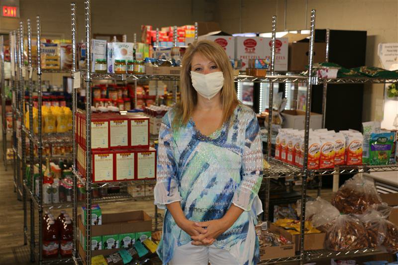 Joy Ashley, executive director at Ephrata Area Social Services, wears a mask at the organization's food bank. (Photo: Kyle Gamble) 