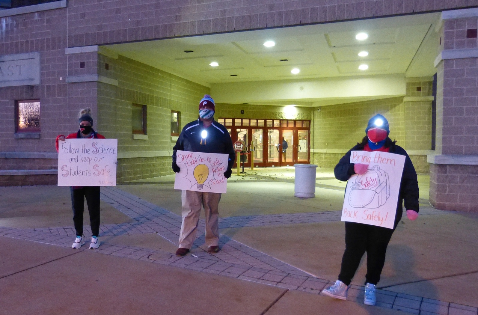 From left, School District of Lancaster teachers Julia Rios, Joe Torres and Toni Allen-King hold signs during a protest outside McCaskey East High School on Tuesday, Nov. 17, 2020. Torres and Allen-King are vice presidents of the Lancaster City Education Association teachers union, which organized the event. (Photo: Tim Stuhldreher)