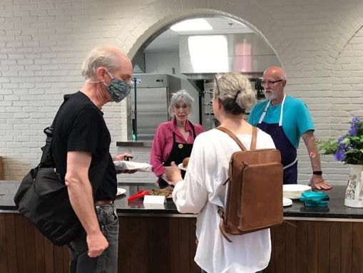 Ellen and Ed Diller at Gypsy Kitchen in Columbia Market House, talking with guests. (Source: Gypsy Kitchen)