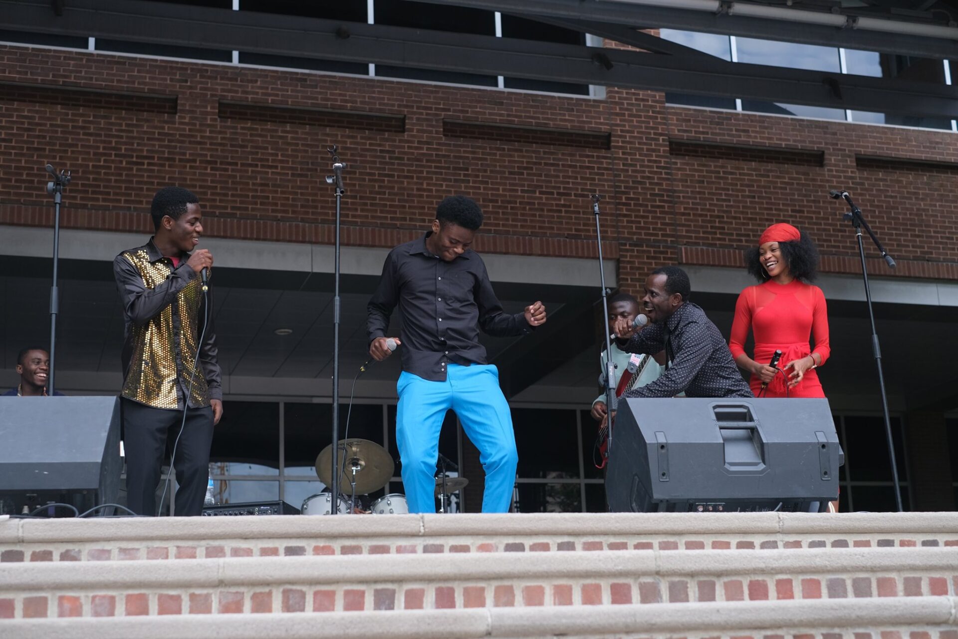 Joel Makeci (crouching, second from right) and NGGBC, the musical act during Music For Everyone's Music Friday in honor of World Refugee Day on June 23. (Source: Church World Service)