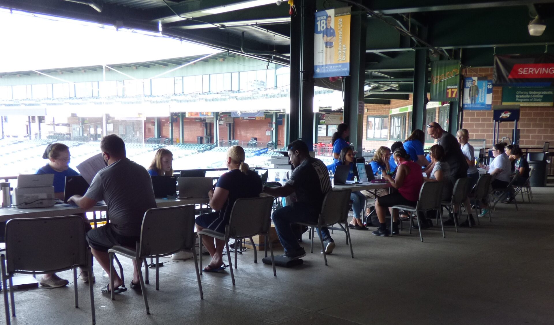 Staff from the Lancaster County Redevelopment Authority and local nonprofits assist clients with Emergency Rental Assistance Program applications at the Rental & Utility Assistance Community Days event at Clipper Magazine Stadium in Lancaster on Friday, July 23, 2021. (Photo: Tim Stuhldreher) 