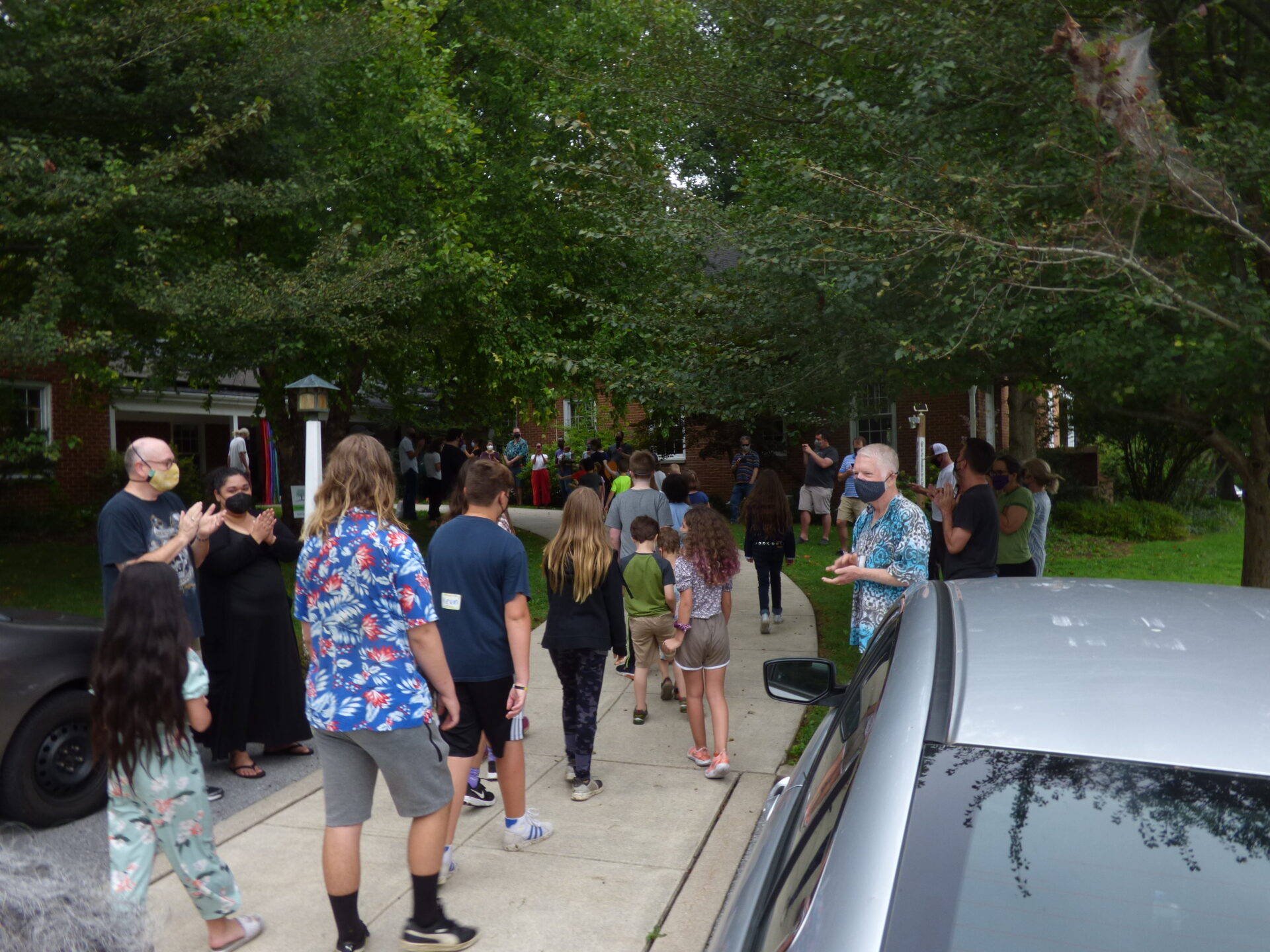 Parents and staff cheer as students enter Lancaster Friends Meeting House for the first day of classes at Lancaster Friends School on Monday, Aug. 30, 2021. (Photo: Tim Stuhldreher) 