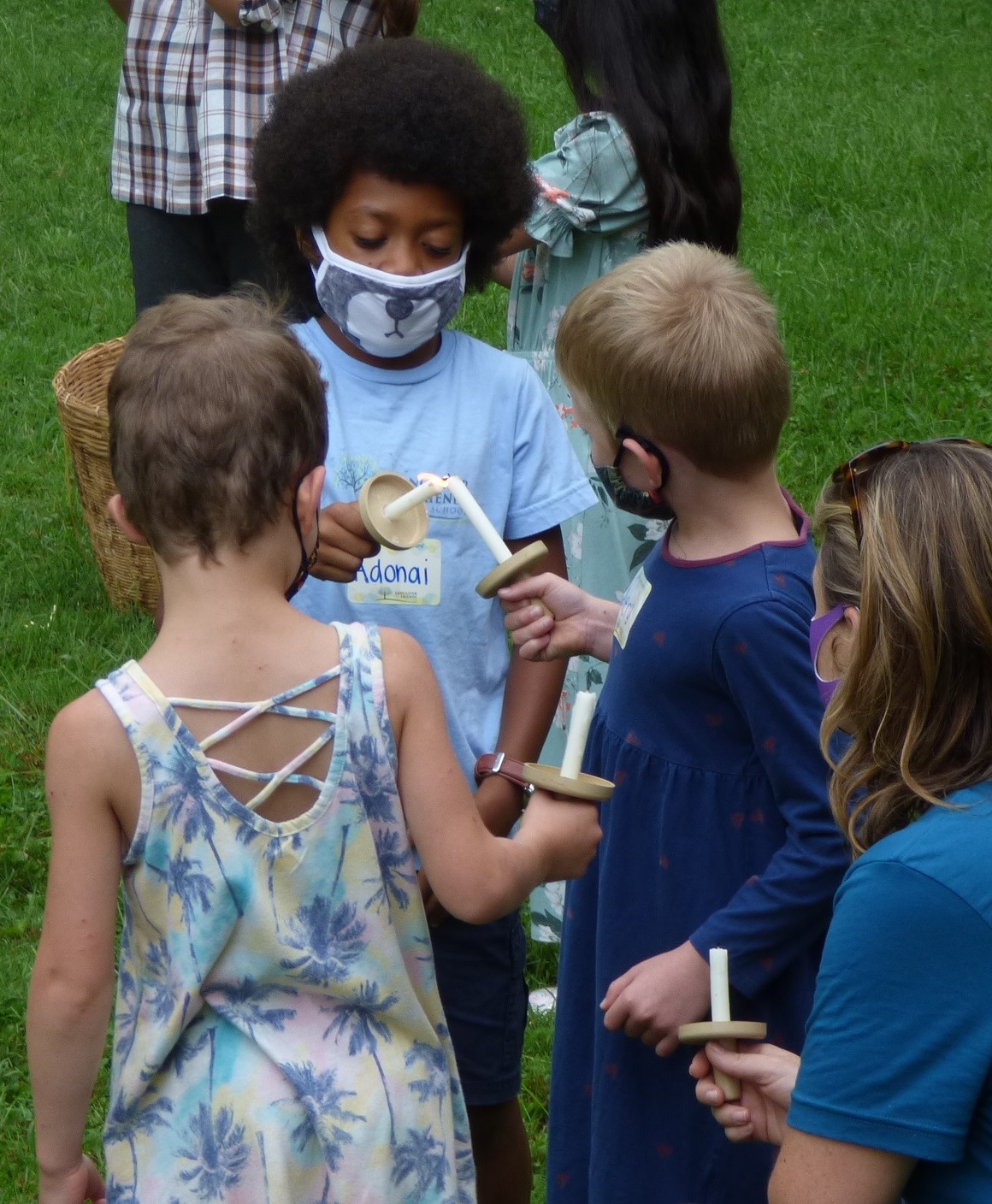 Lancaster Friends School students light each other's candles during the school's opening ceremony on Monday, Aug. 30, 2021. (Photo: Tim Stuhldreher) 