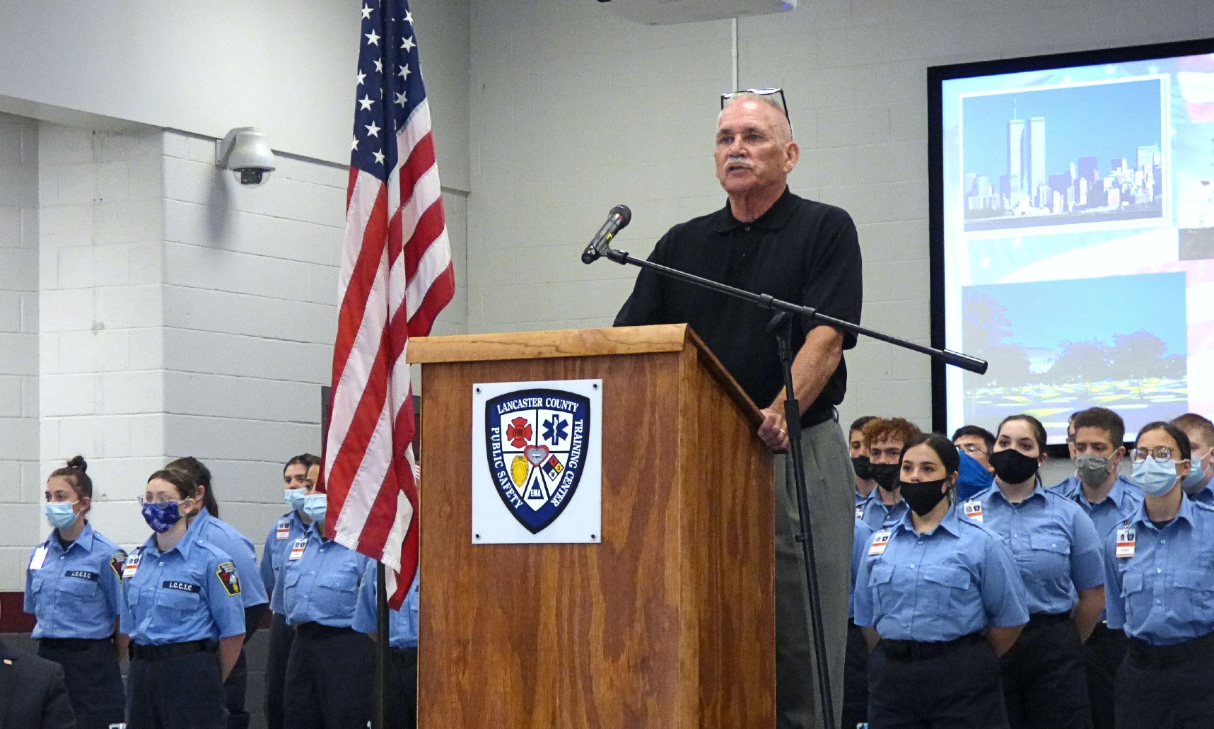 Greg Noll speaks about his experiences at Ground Zero in New York City during a Sept. 11 Remembrance Service  at the Lancaster County Public Safety Training Center on Friday, Sept. 10, 2021. Behind him are cadets from the Lancaster County Career and Technology Center’s Protective Services program. (Photo: Tim Stuhldreher)