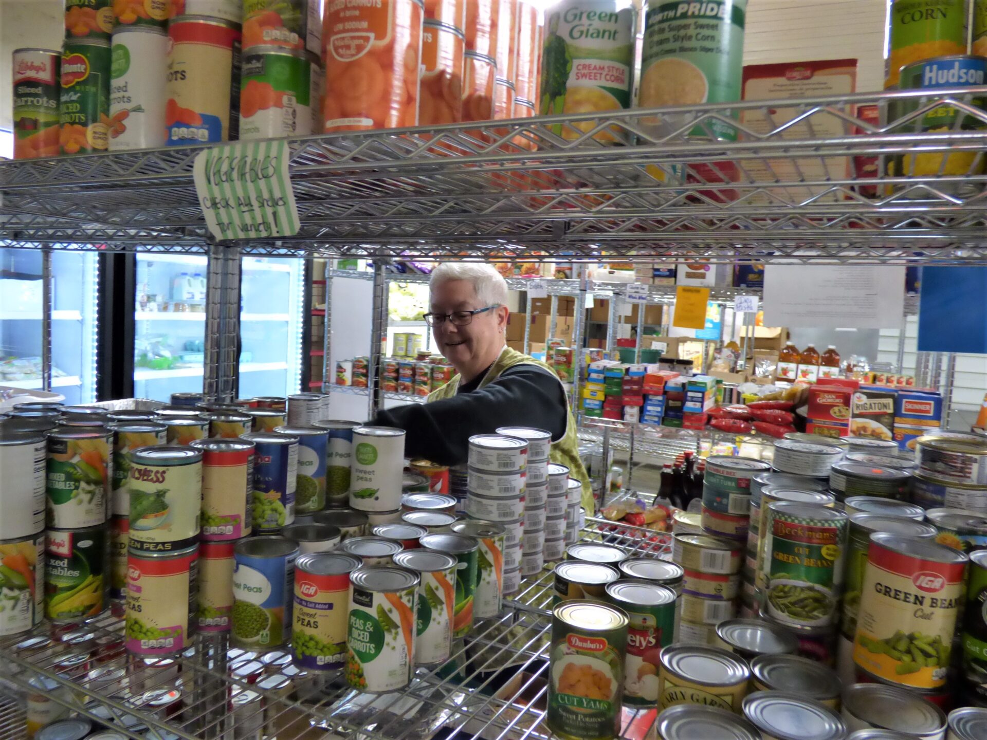 Volunteer Jan Long stocks shelves at the Ephrata Area Social Services' Hand UP food pantry on Friday, Nov. 19, 2021. (Photo: Tim Stuhldreher) 