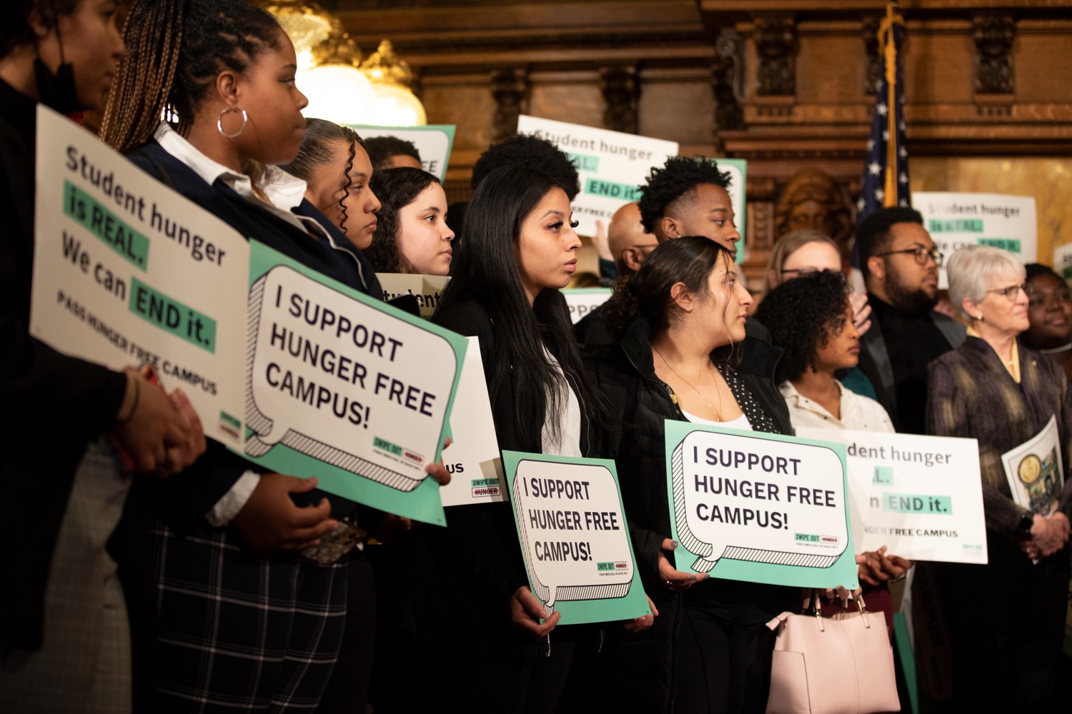 Students from public colleges and universities in Pennsylvania hold signs during the event. (Source: Pa.gov)