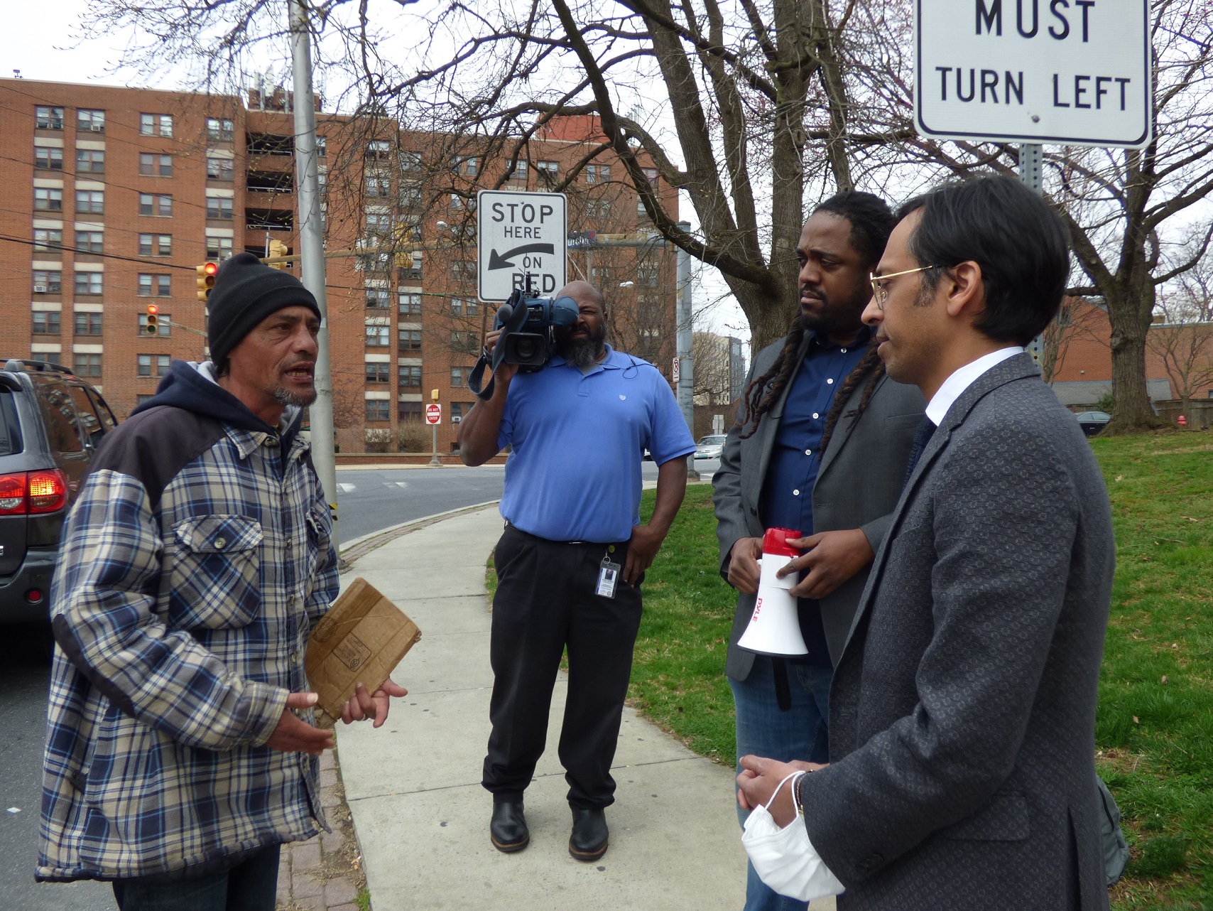 Juan Gonzalez, left, talks with City Council President Ismail Smith -Wade-El, second from right, and state Sen. Nikil Saval, D-Philadelphia, right, on North Duke Street. (Photo: Tim Stuhldreher) 