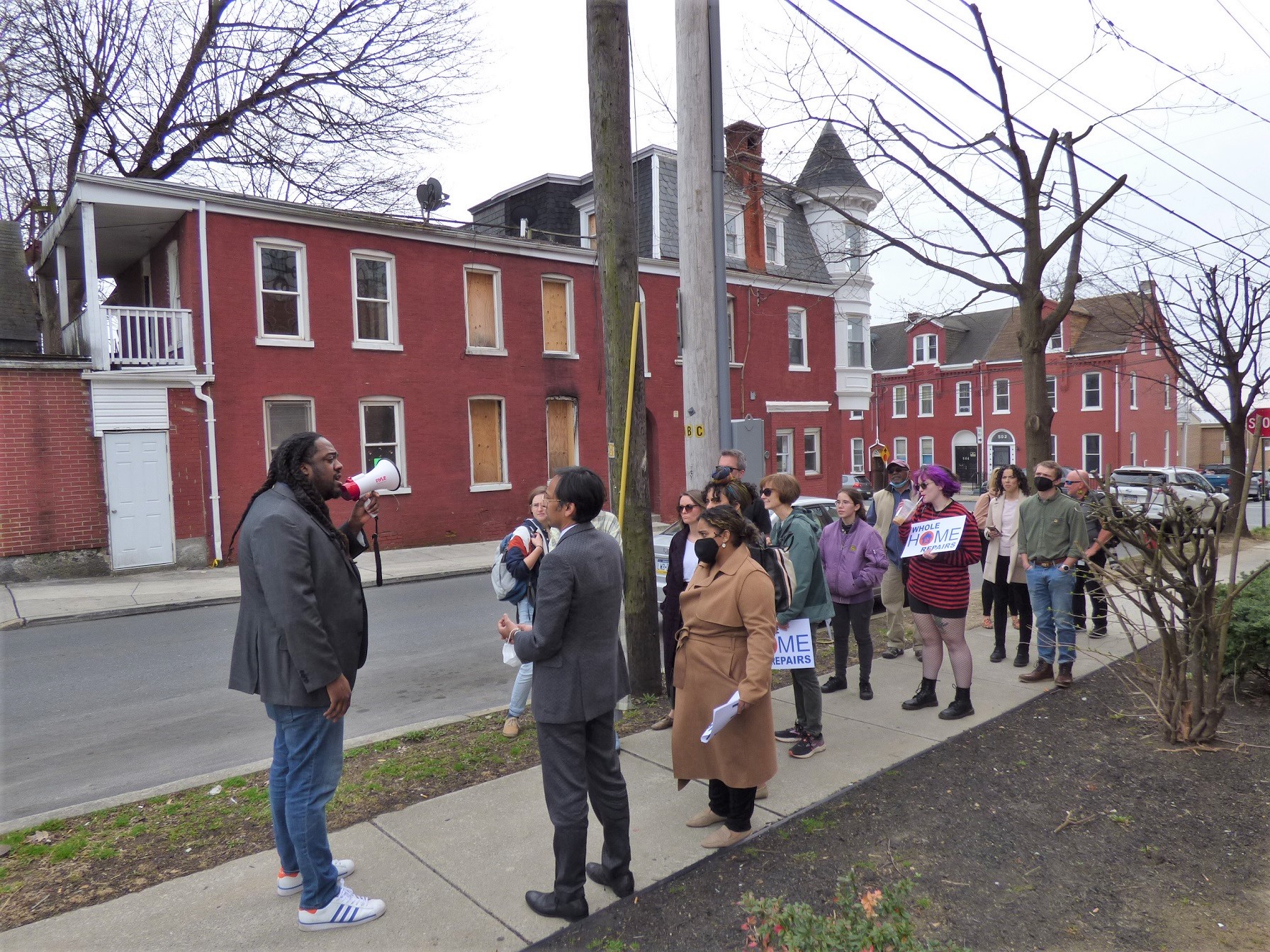 The tour pauses to discuss a condemned property at the corner of South Lime and Chester streets. (Photo: Tim Stuhldreher) 