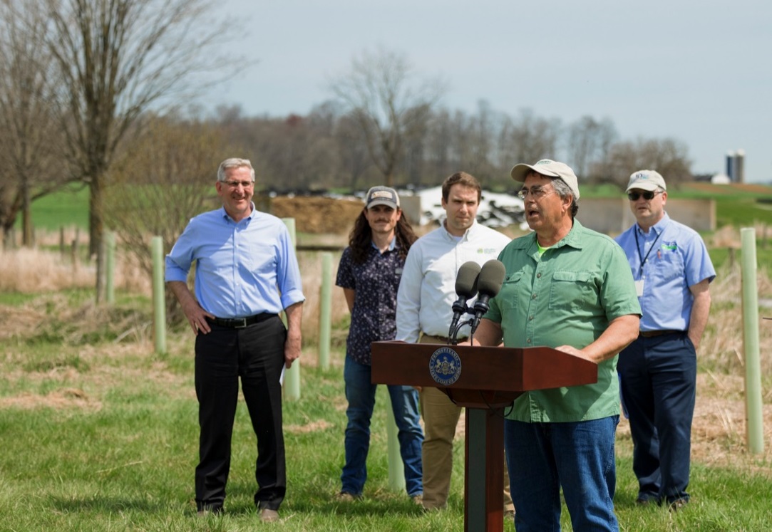 Gordon Hoover, owner of Welsh Vista Farms, speaks about his environmental preservation efforts. Behind him are, from left, Pa. Agricultural Secretary Russell Redding; Ryan Davis, senior forests project manager, Alliance for the Chesapeake Bay; Jeb Musser, vice president of land protection, Lancaster Farmland Trust; and Karl Brown, executive director, Pa. State Conservation Commission (Source: Pa.gov)