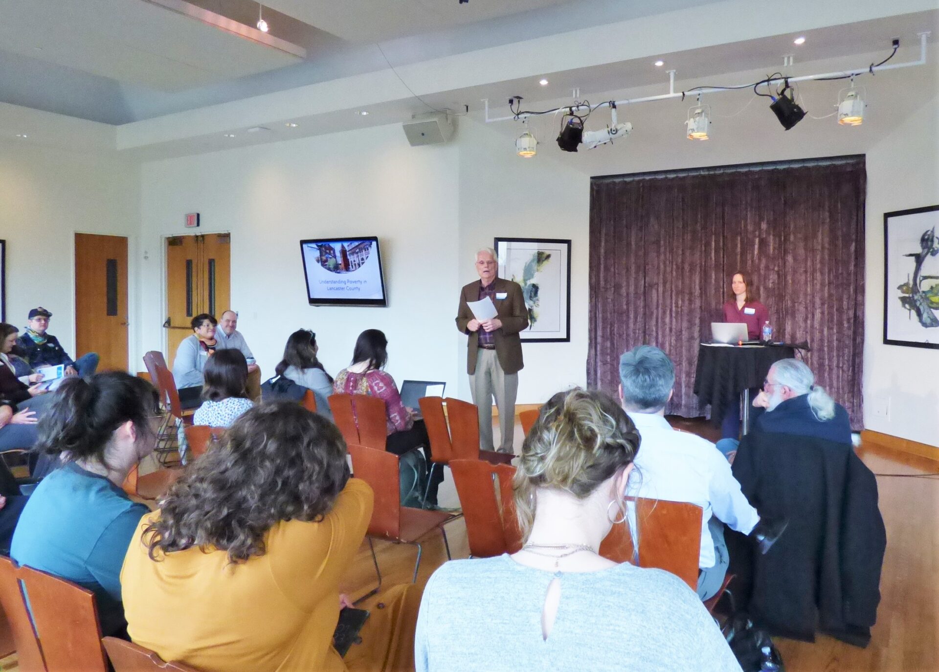 Bob Thomas, standing at center, and Rachel Luehm, at center-right, kick off a session on poverty impacts during Lancaster2040 at the Ware Center in Lancaster on Thursday, March 31, 2022. (Photo: Tim Stuhldreher)