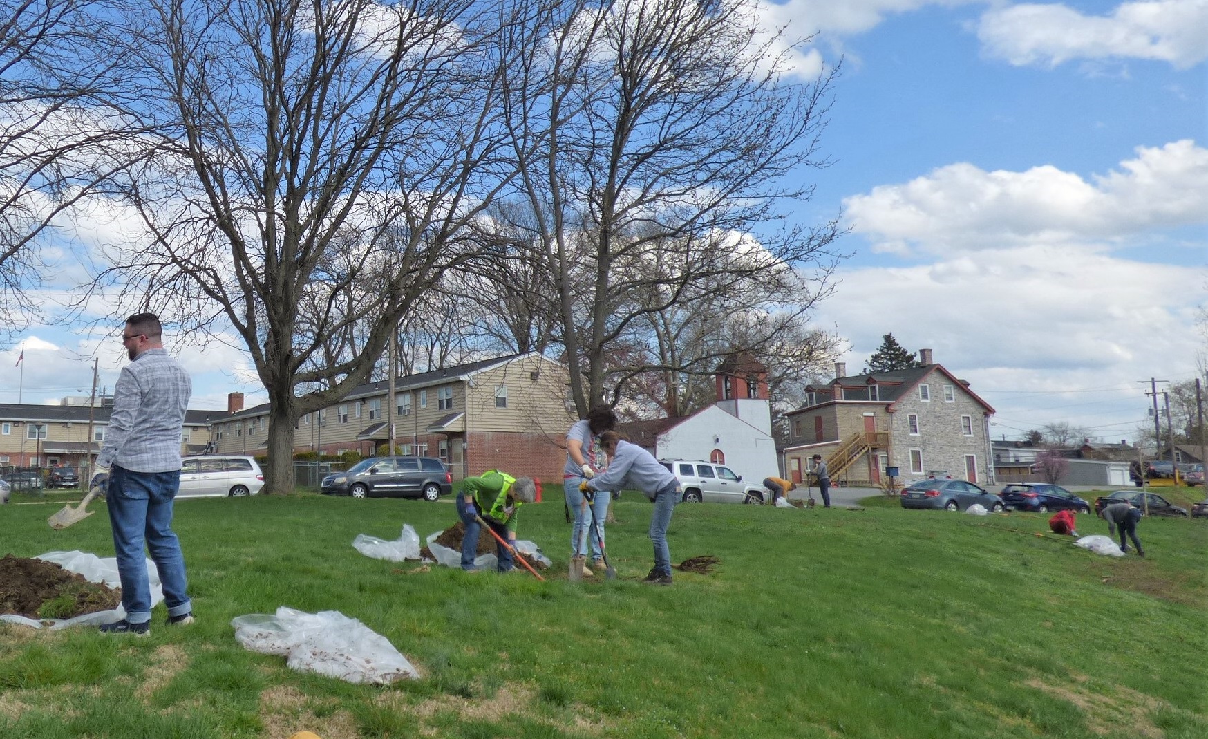 Tree planting proceeds along a slope on east side of the Susquehanna Court complex. (Photo: Tim Stuhldreher)