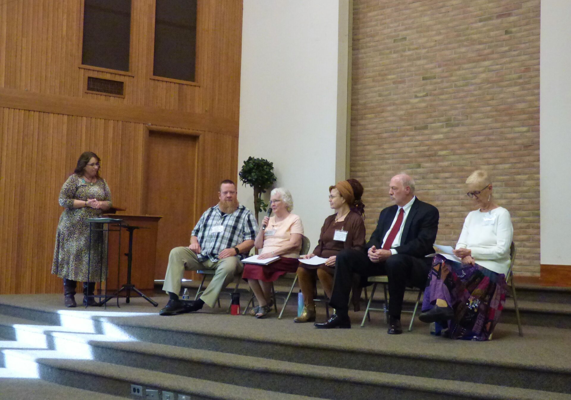 Plain Communities Task Force Lizzie Hershberger, left, moderates a panel on the Plain Communities Task Force featuring, from left, Scott MacDerment, Mary Boll, Pamela Craddock, Judge Dennis Reinaker and Linda Crockett, at Forest Hills Mennonite Church on Friday, Apr. 29, 2022. (Photo: Tim Stuhldreher)