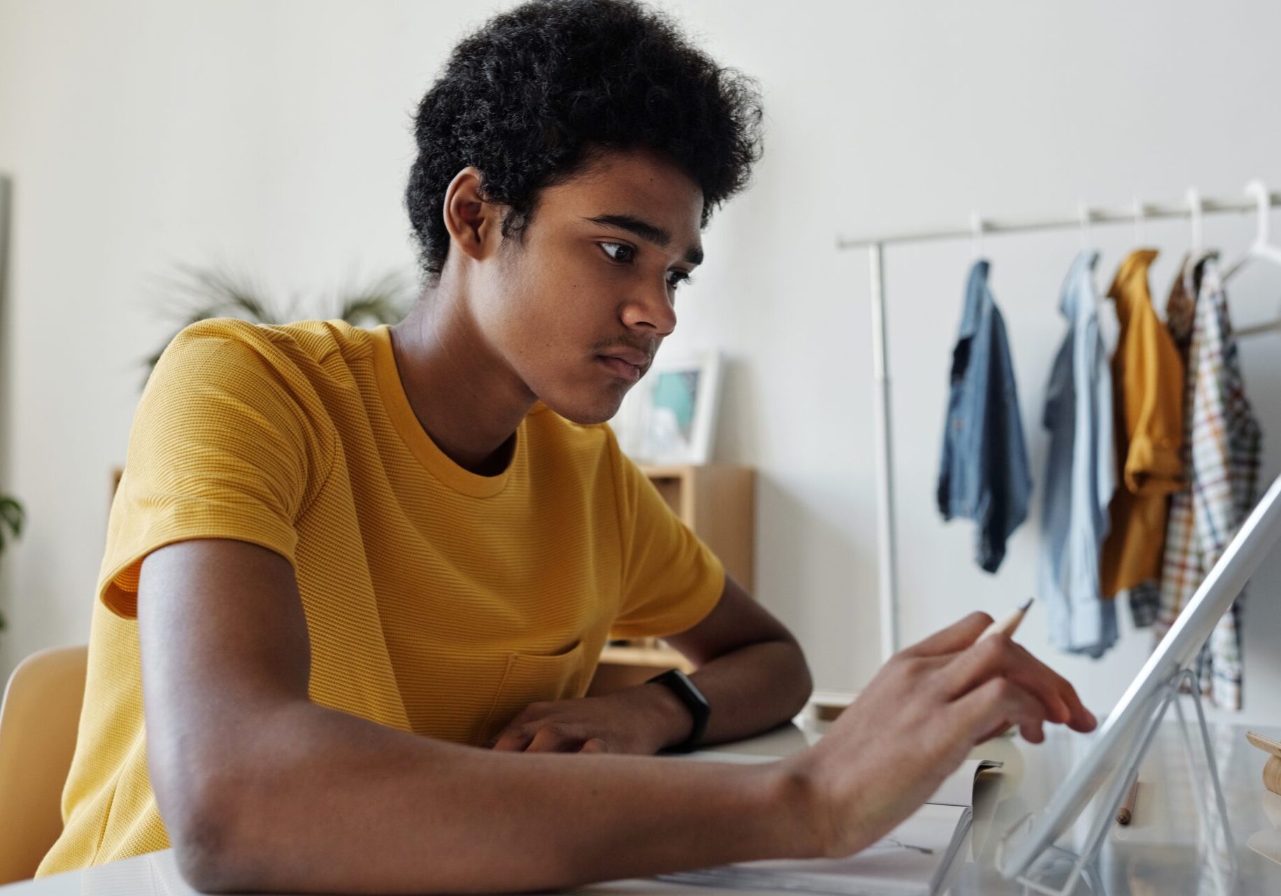 man-in-yellow-crew-neck-t-shirt-while-using-tablet-4144096 man-in-yellow-crew-neck-t-shirt-while-using-tablet-4144096